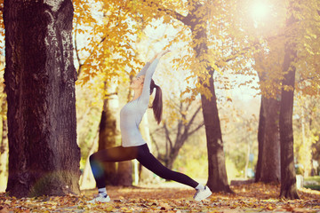 Pretty young girl exercise in the park