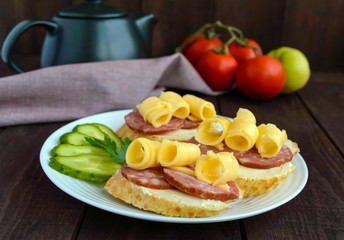 Classic sandwich with sausage and cheese on white baguette. Breakfast