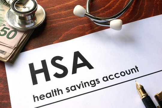 Paper with words  health savings account (HSA) on a table.