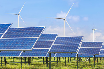 Photovoltaics  module  solar panels and wind turbines generating electricity renewable green energy with blue sky background 