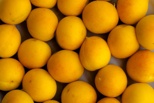 Fresh yellow apricot background texture.