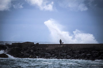 Fototapeta na wymiar Stone breakwater with breaking waves.