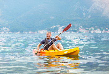 Mature man kayaking on the sea