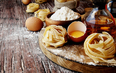 Uncooked pasta with flour on the table, selective focus