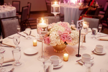 Little candles shine floating on the water in crystal vases