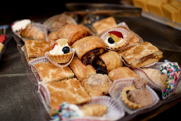 Different kinds of Indian sweets lie on the steel tray