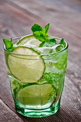 refreshing drink mojitos on wooden table decorated with brown sugar