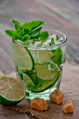 refreshing drink mojitos on wooden table decorated with brown sugar