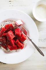 Summer salad of watermelon and yogurt, with poppy and sesame seeds