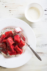 Summer salad of watermelon and yogurt, with poppy and sesame seeds