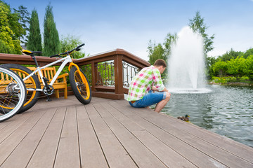Guy sitting on the wooden deck after biking