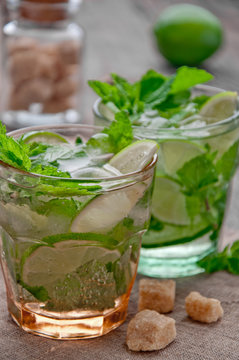 refreshing drink mojitos on wooden table decorated with brown sugar