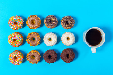 cup of coffee and donut isolated on blue background
