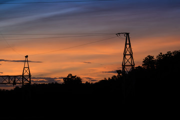 Fototapeta na wymiar Silhouette of Electric Power Lines and High power transmission line at sunset