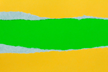 Torn yellow paper with a green background