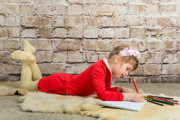 Fototapeta premium Girl draws pencil on the album. School Education, Art.