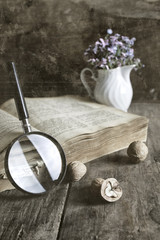old scratched effect on photo magnifying glass and old book
