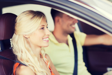 happy man and woman driving car