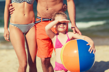 close up of family with inflatable ball on beach