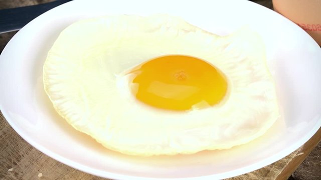 Rotating fried Eggs as not loopable 4K UHD footage