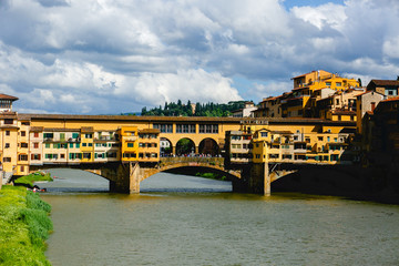 Yellow buildings stand on the bridge over the river