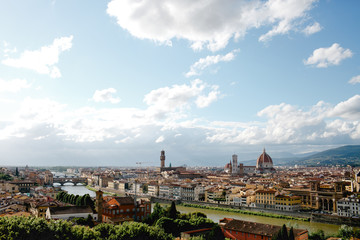 Fototapeta na wymiar White clouds fly over the houses of Florence