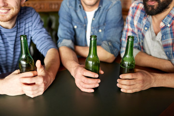 happy male friends drinking beer at bar or pub