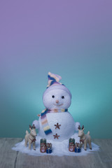 nice snowmen on wooden and green background