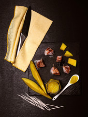frilled pork fillet and mango delicious sauce over slate