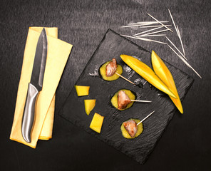 frilled pork fillet and mango delicious sauce over slate