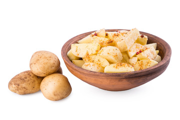 Sliced potatoes in a clay bowl isolated on white background.