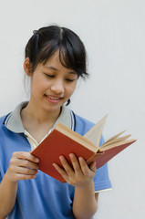 Obraz premium Asian Teenager Girl Enjoy Reading A Book.