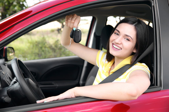 Woman holding key in car