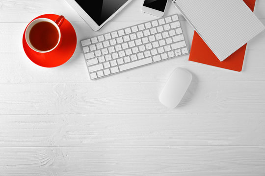 Modern workplace with cup of tea, top view