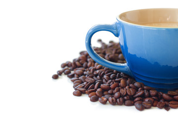 Blue coffee cup next and roasted beans isolated on white