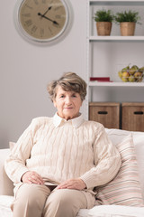 Elderly woman resting on couch