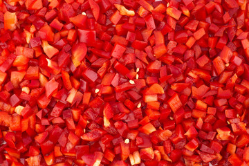 Chopped red peppers texture background.