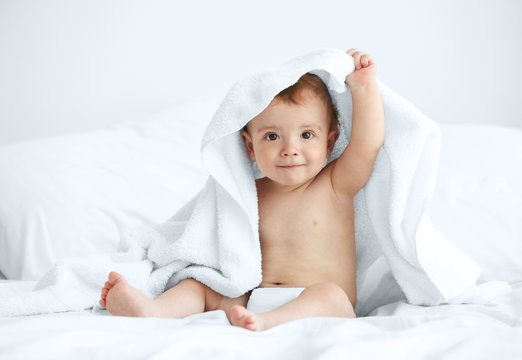 Cute baby sitting on the bed