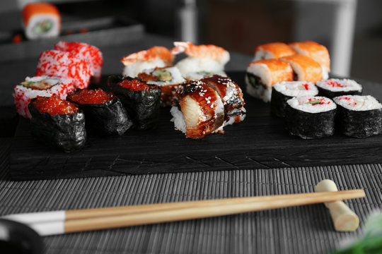 Sushi set on wooden board and chopsticks