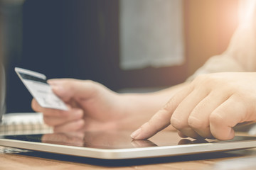 Online payment,Woman's hands holding a credit card and using tab