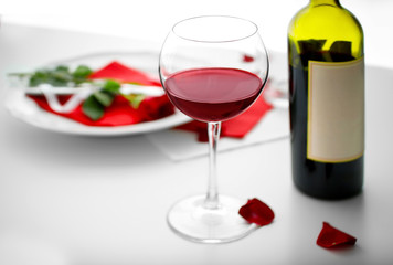 Fototapeta na wymiar Romantic table setting with wine closeup