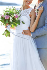 Groom and bride hugging, outdoor