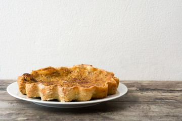 Homemade pumpkin pie on wooden background

