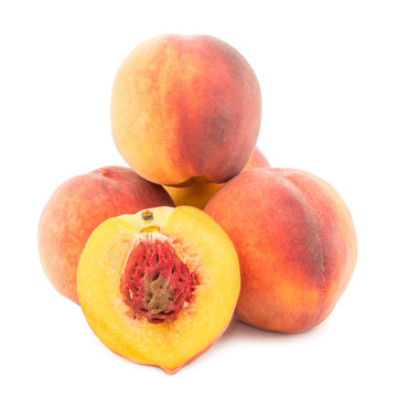 Ripe peaches closeup isolated on white background.