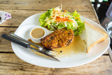 steak and salad on white dish