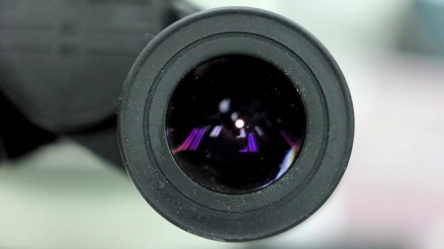 look into the microscope with a gradual zooming