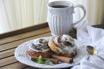Homemade cinnabons cinnamon rolls with cream cheese glaze. 