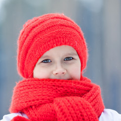 Happy boy in costumes snowman walking in winter forest,