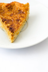 Homemade pumpkin pie on a plate isolated on white background