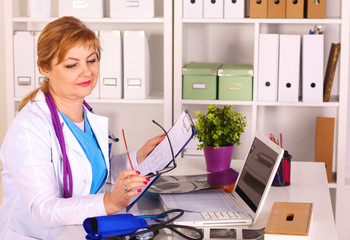 the wife of the doctor at the desk in the office